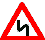 Знак 1.12.2  «с первым поворотом налево»